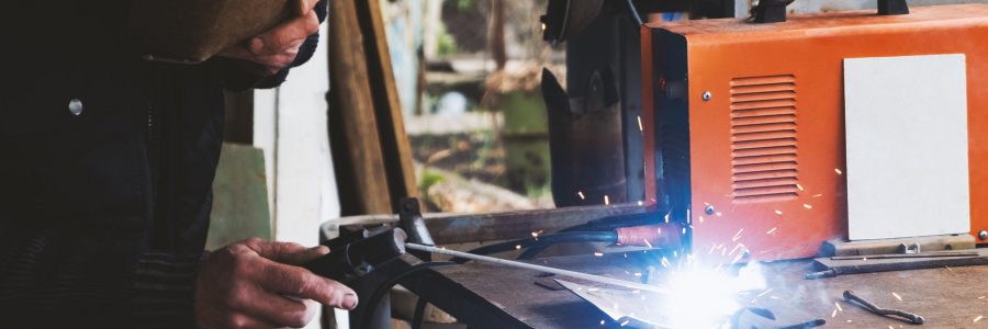 Man welding old shovel, close up